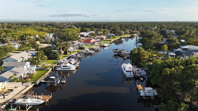 birds eye view of property featuring a residential view, a water view, and a forest view