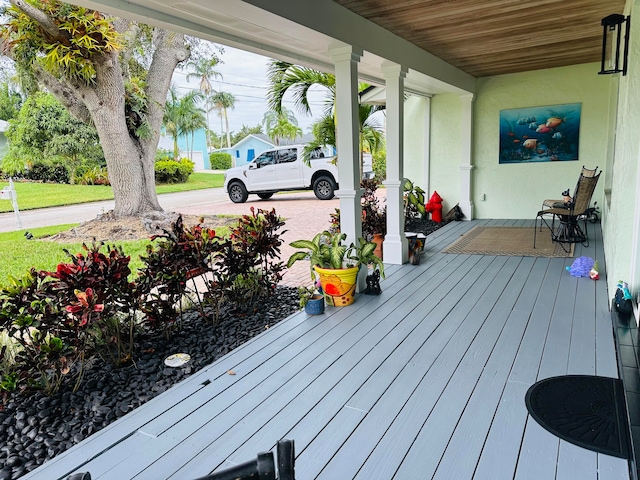 wooden terrace with a porch