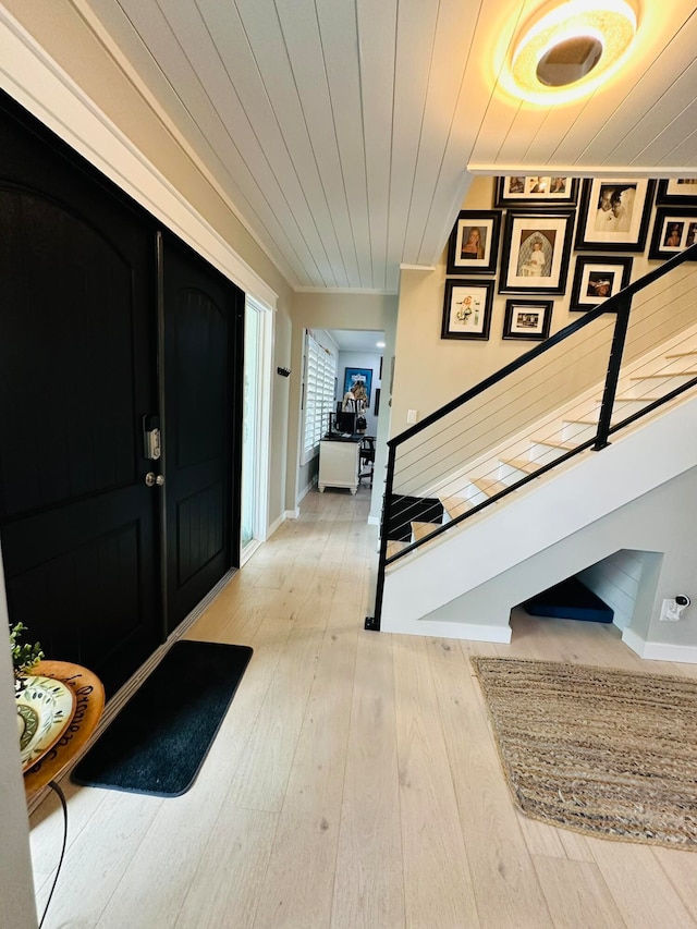 foyer entrance with wood ceiling and wood-type flooring