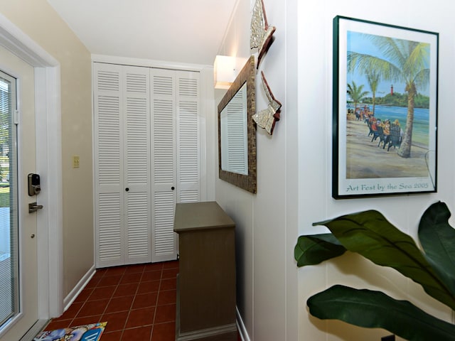 hallway with a water view and dark tile flooring