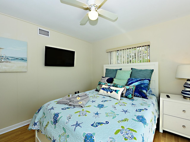 bedroom featuring ceiling fan and dark wood-type flooring