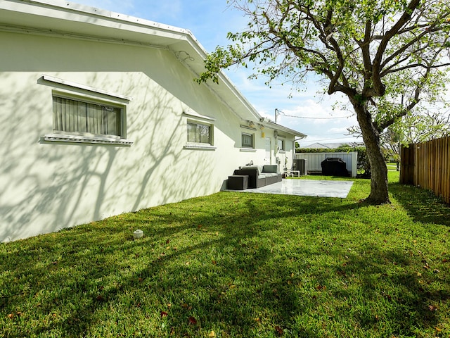 view of property exterior featuring a patio, an outdoor hangout area, and a yard