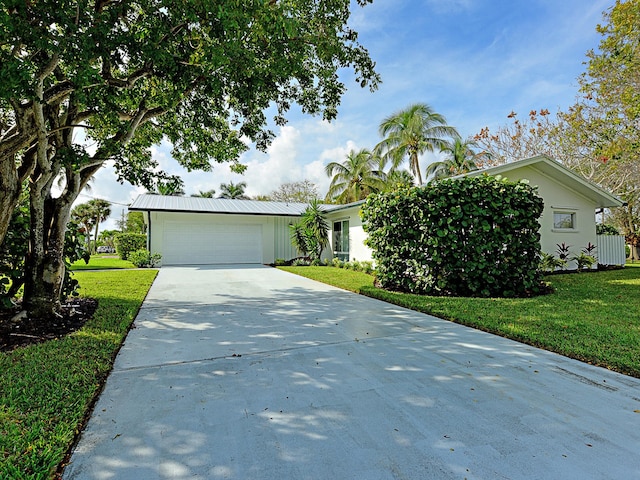 single story home with a front lawn and a garage