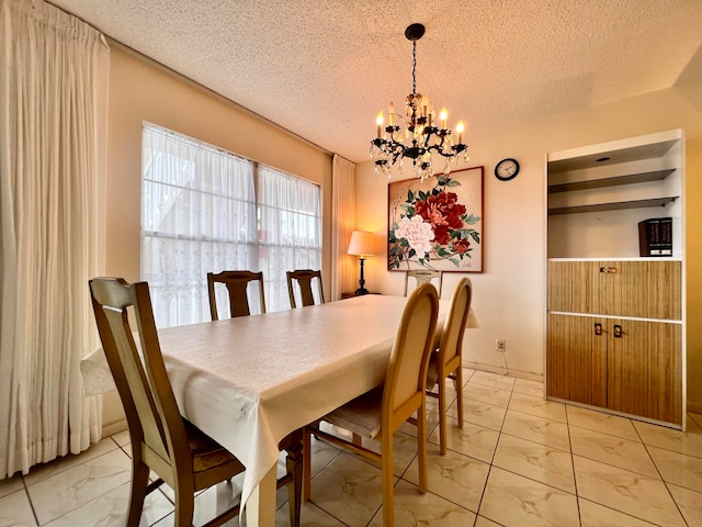 tiled dining area featuring an inviting chandelier and a textured ceiling