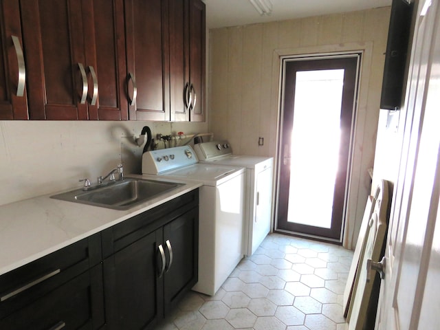 washroom featuring cabinets, independent washer and dryer, light tile patterned floors, and sink