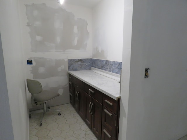 bathroom with tile patterned flooring, vanity, and tile walls