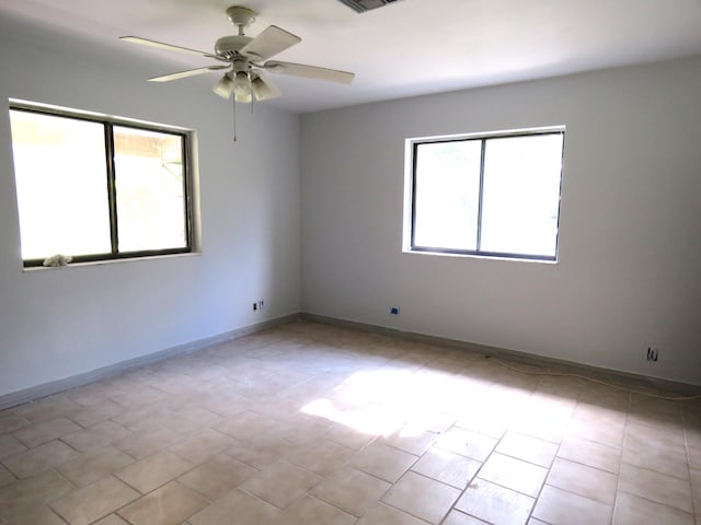 empty room with plenty of natural light and ceiling fan