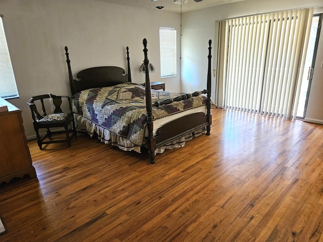 bedroom featuring hardwood / wood-style floors and multiple windows