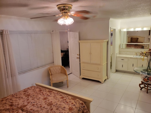 tiled bedroom with ornamental molding, ceiling fan, a textured ceiling, and sink