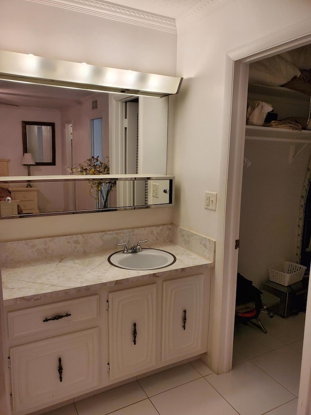 bathroom with oversized vanity, ornamental molding, and tile flooring