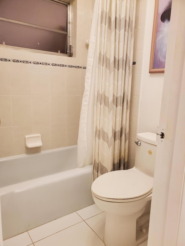 bathroom featuring shower / tub combo, tile flooring, and toilet