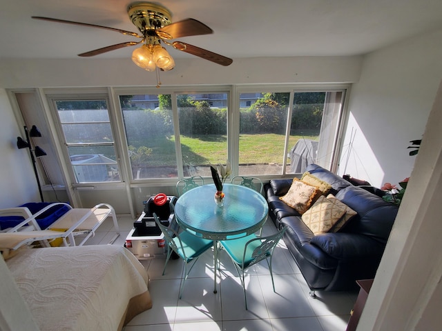 sunroom / solarium featuring ceiling fan