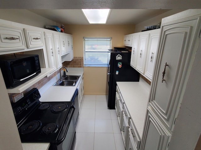 kitchen featuring white cabinetry, light tile floors, black appliances, and sink