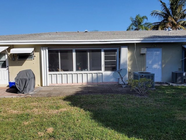 view of front of house featuring a front lawn and central air condition unit