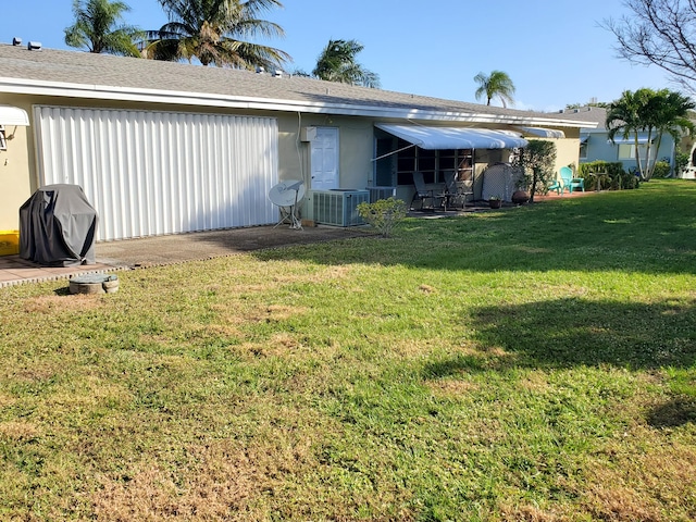 exterior space with a lawn and central air condition unit