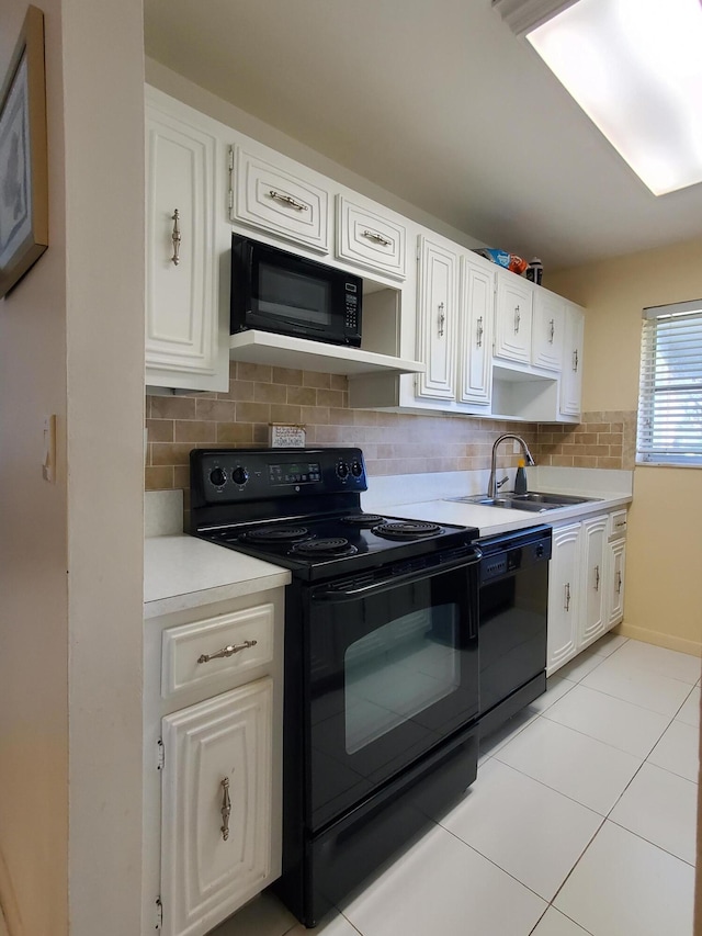 kitchen featuring white cabinetry, tasteful backsplash, black appliances, and sink