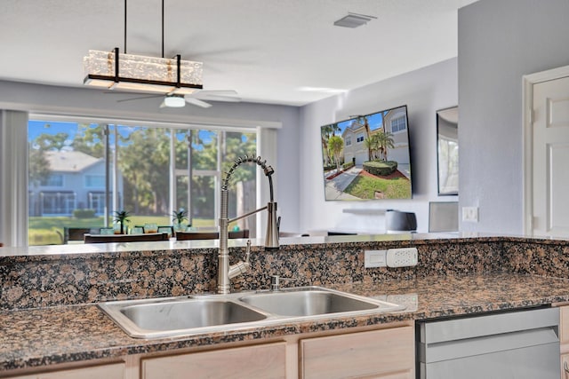 kitchen with hanging light fixtures, sink, dishwashing machine, and ceiling fan