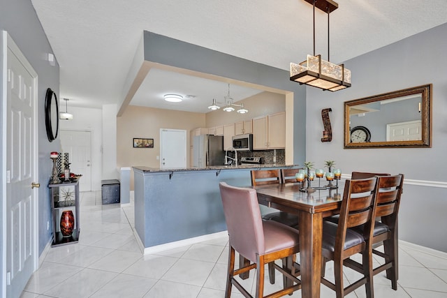 dining area featuring light tile patterned flooring