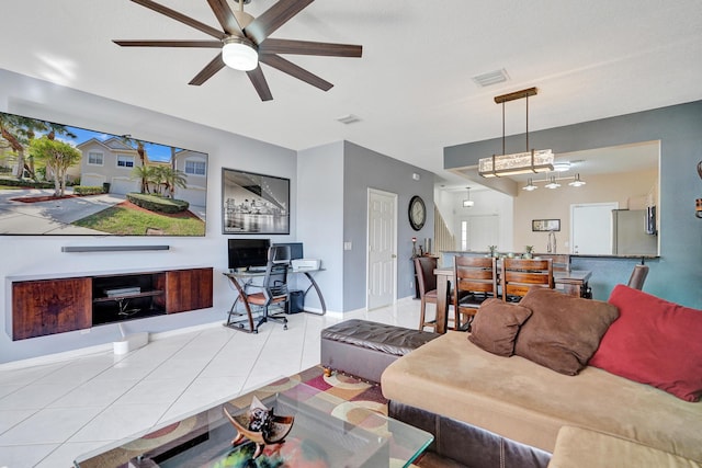 living room featuring visible vents, ceiling fan, baseboards, and tile patterned floors