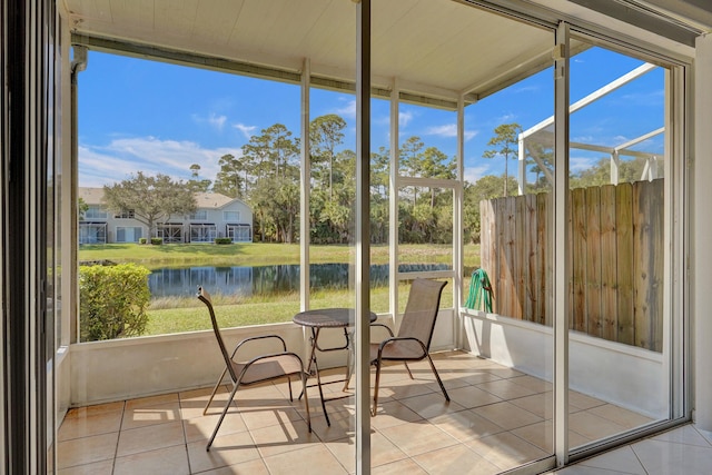 unfurnished sunroom with a water view and a healthy amount of sunlight