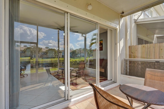 doorway featuring light tile patterned flooring and a water view