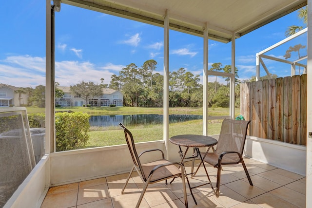 sunroom / solarium with a water view