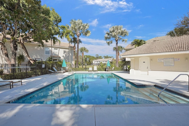 pool featuring a patio area and fence