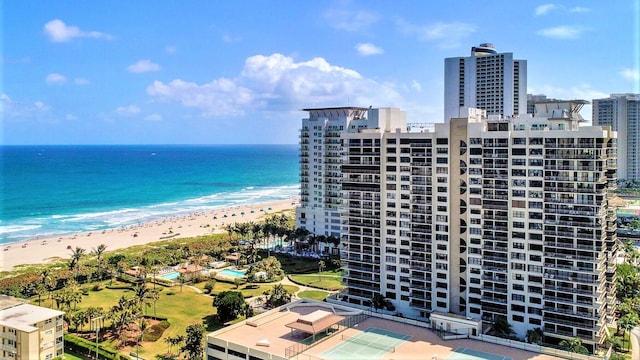 birds eye view of property with a water view and a beach view