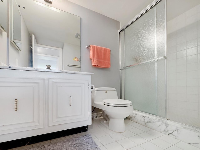 bathroom featuring toilet, tile flooring, an enclosed shower, and vanity