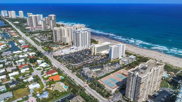 drone / aerial view featuring a water view and a view of the beach