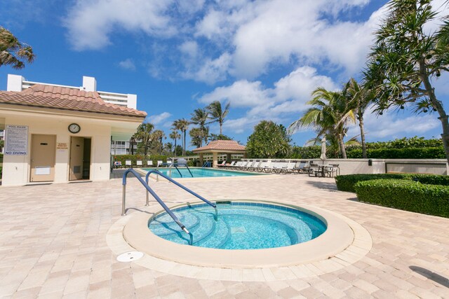 view of pool featuring a hot tub and a patio