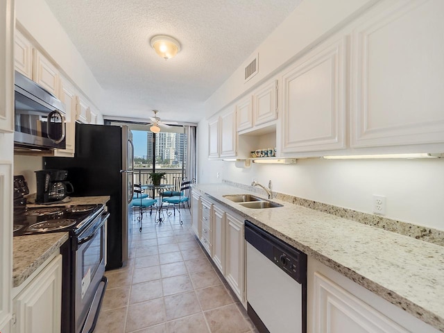 kitchen featuring white dishwasher, range with electric cooktop, ceiling fan, white cabinetry, and sink