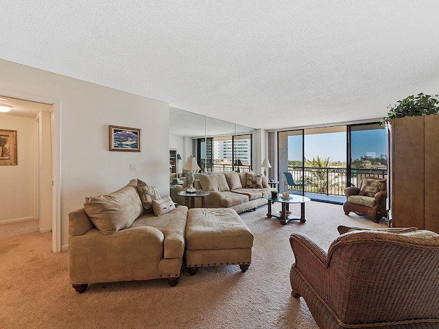 carpeted living room with floor to ceiling windows and a textured ceiling