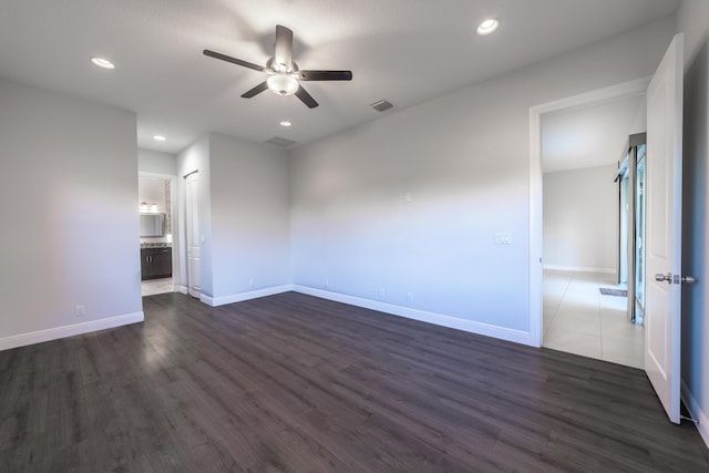 interior space with dark hardwood / wood-style floors and ceiling fan