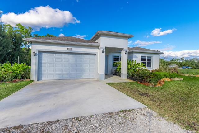 view of front of home featuring a front yard and a garage