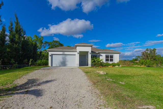 view of front of house with a garage and a front yard