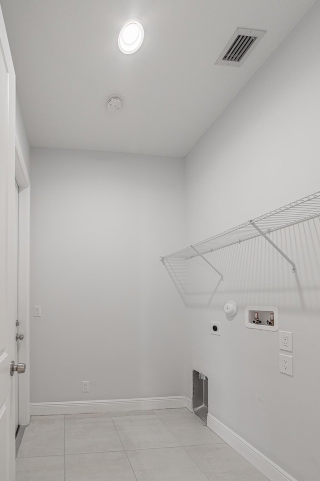 washroom featuring hookup for a washing machine, light tile patterned floors, gas dryer hookup, and electric dryer hookup