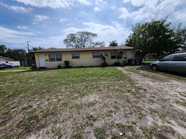 single story home with a front lawn