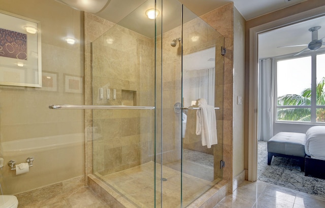 bathroom featuring ceiling fan and an enclosed shower