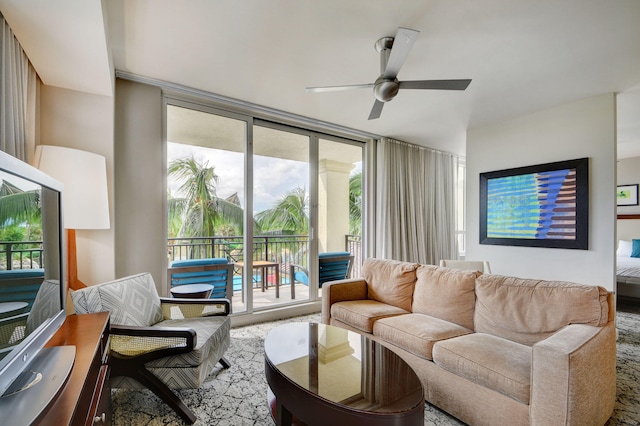 living room featuring ceiling fan, carpet, and a wall of windows