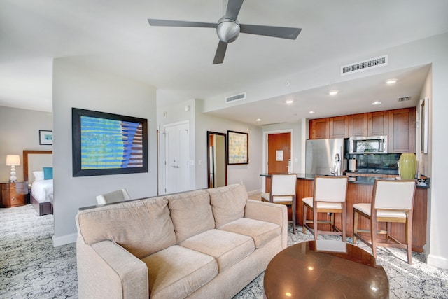 living room with light carpet and ceiling fan