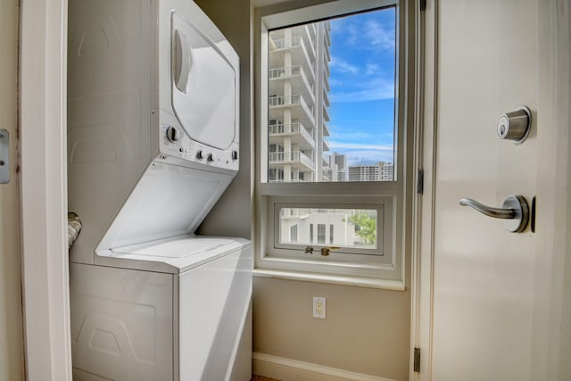 washroom featuring stacked washer / dryer