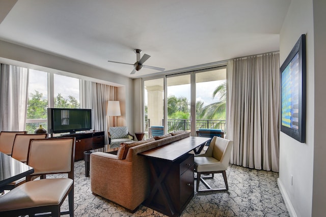 living room with ceiling fan and expansive windows