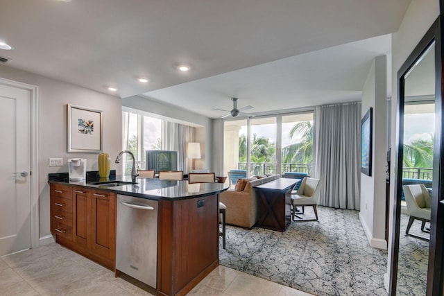 kitchen with kitchen peninsula, floor to ceiling windows, ceiling fan, sink, and dishwasher