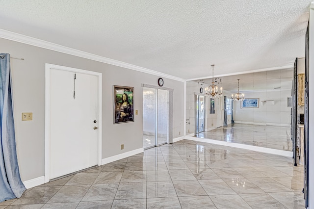 tiled spare room featuring a notable chandelier, a textured ceiling, and crown molding