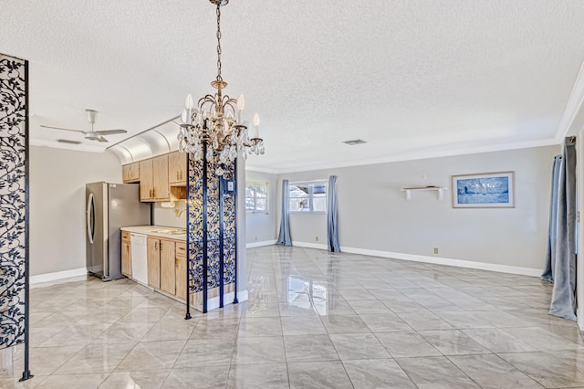 interior space with light tile floors, a textured ceiling, ceiling fan with notable chandelier, and ornamental molding