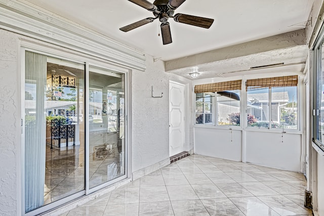 interior space featuring light tile floors and ceiling fan