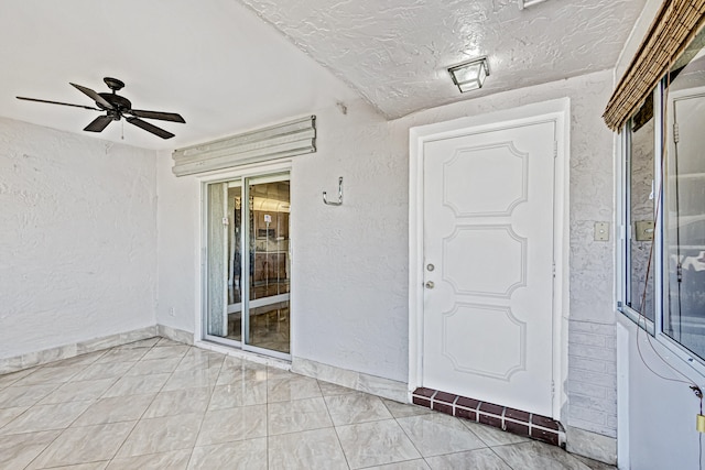 entrance to property with ceiling fan