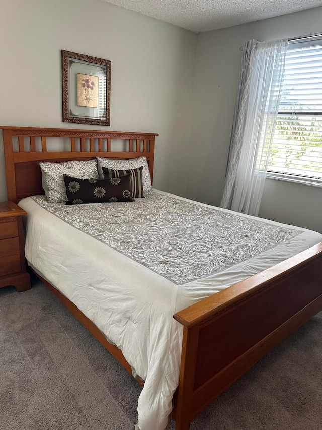 carpeted bedroom with a textured ceiling