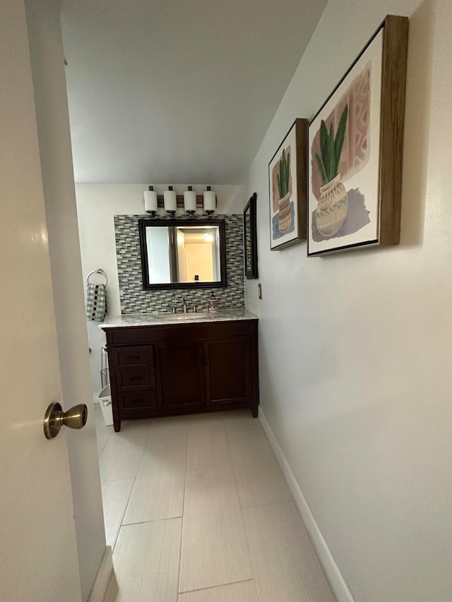 corridor with sink and light tile floors